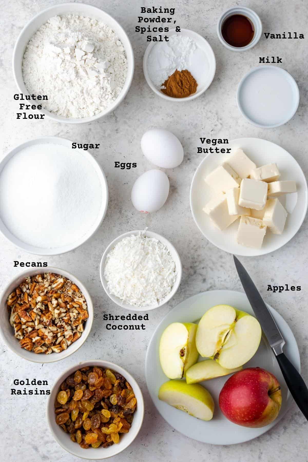 Ingredients for a gluten free apple cake on a white table.