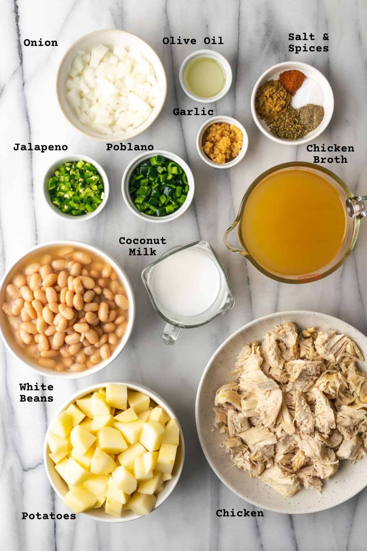 Ingredients for white chicken chili on a marble table.