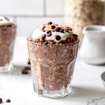 Chocolate peanut butter overnight oats in a glass cup.