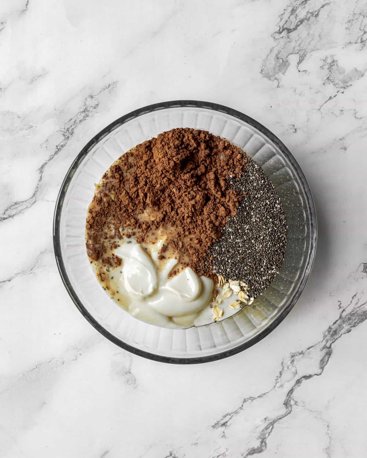 Ingredients together in a large bowl on a white table.