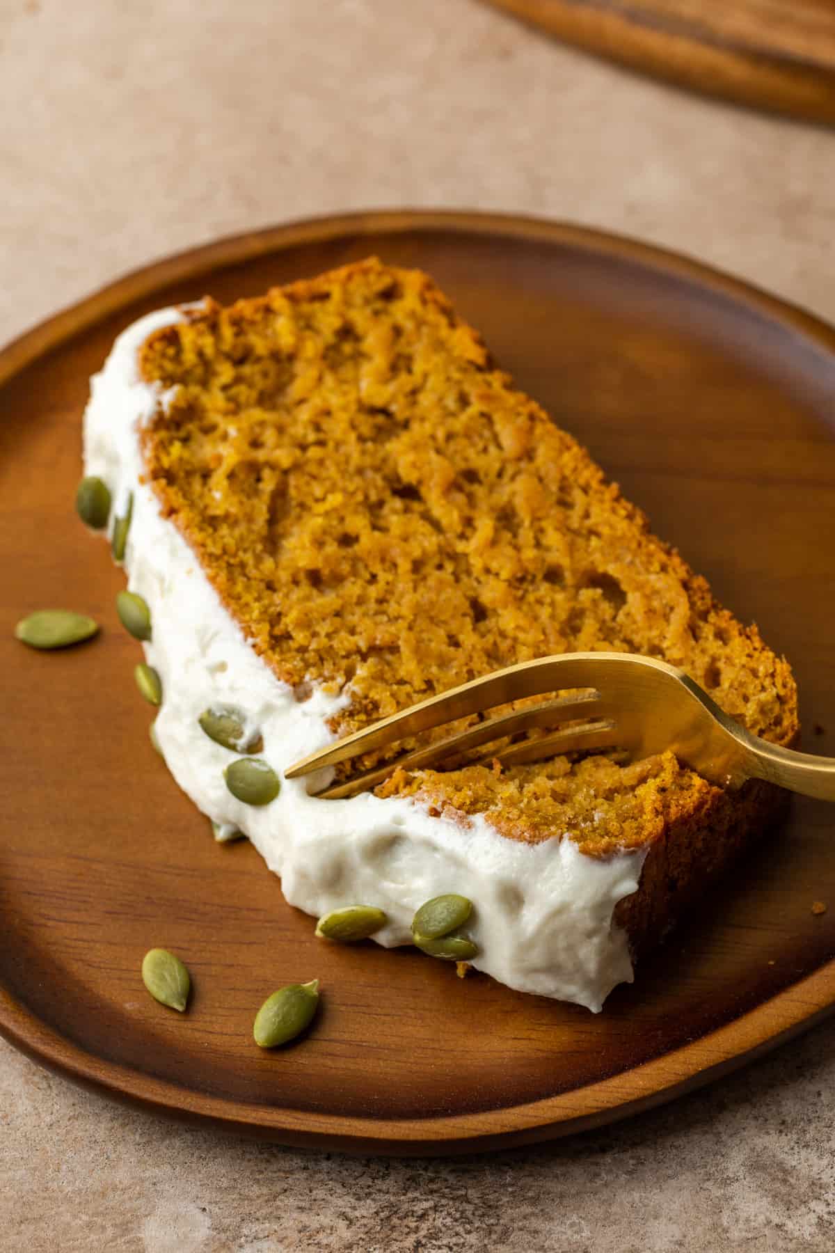 Pumpkin bread being sliced into with a fork.