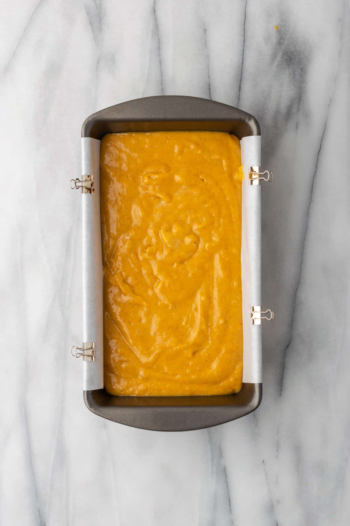 Unbaked batter for pumpkin bread in a loaf pan.