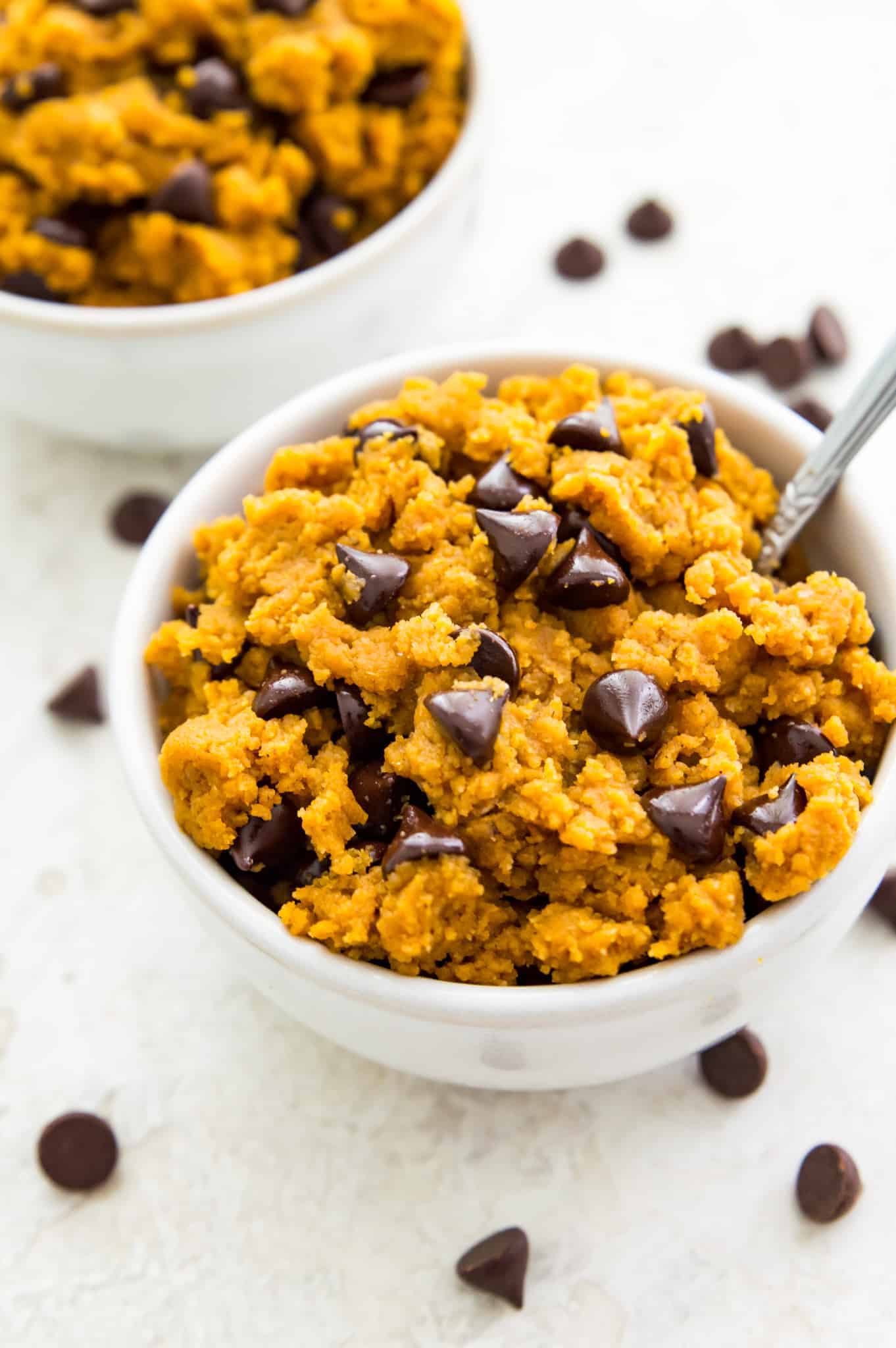 Pumpkin chocolate chip cookie dough in a small white bowl.
