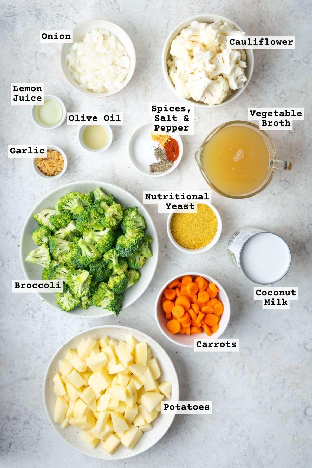 Ingredients for vegan broccoli cheddar soup on a white table.