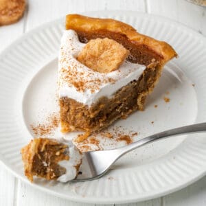 A slice of apple butter pie on a white plate.