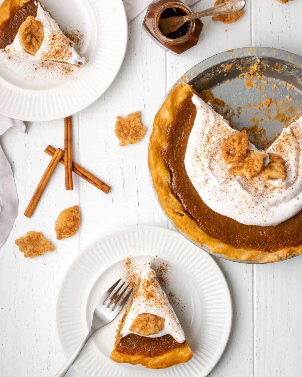 A sliced apple butter pie on a white table.