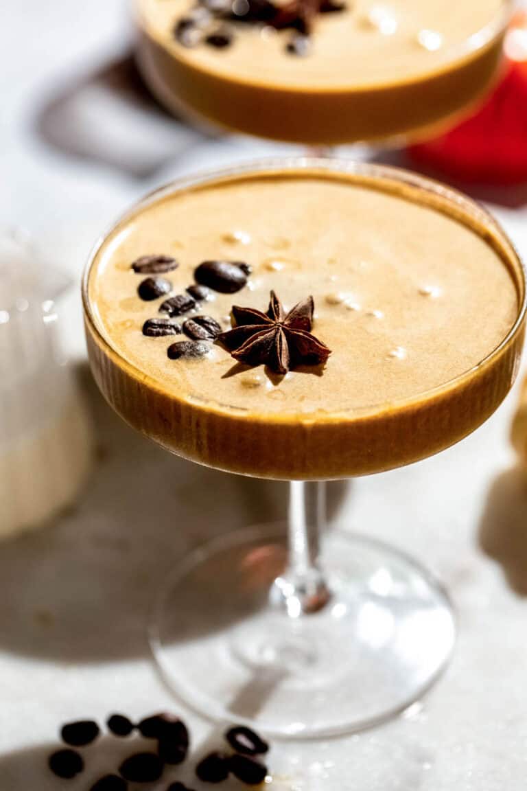 A pumpkin espresso martini served in a coupe glass and garnished with espresso beans.