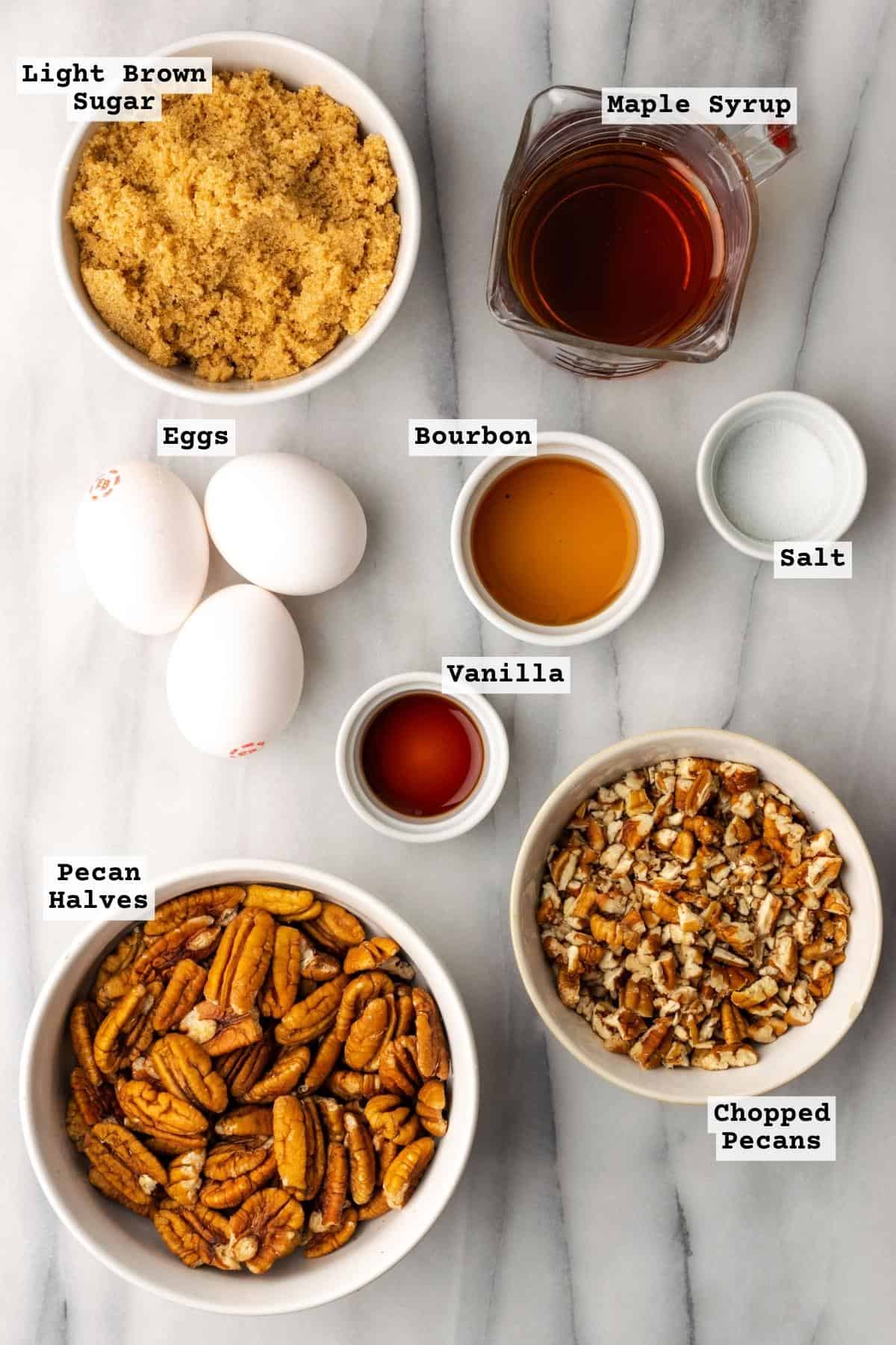 Ingredients for gluten free pecan pie on a white marble table.