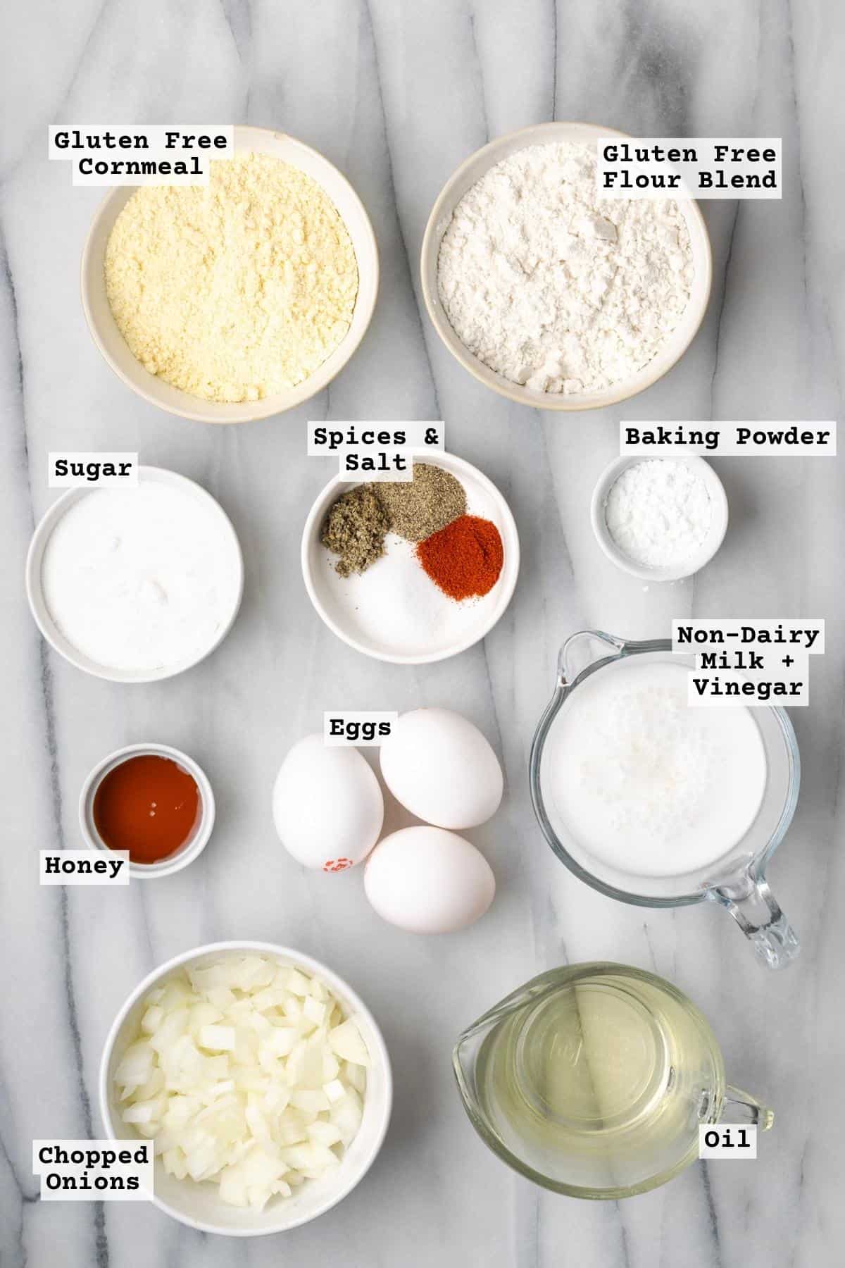 Ingredients for gluten free cornbread on a white marble table.