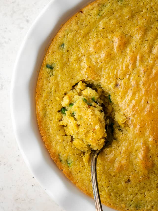 Gluten free corn casserole in a white baking dish.