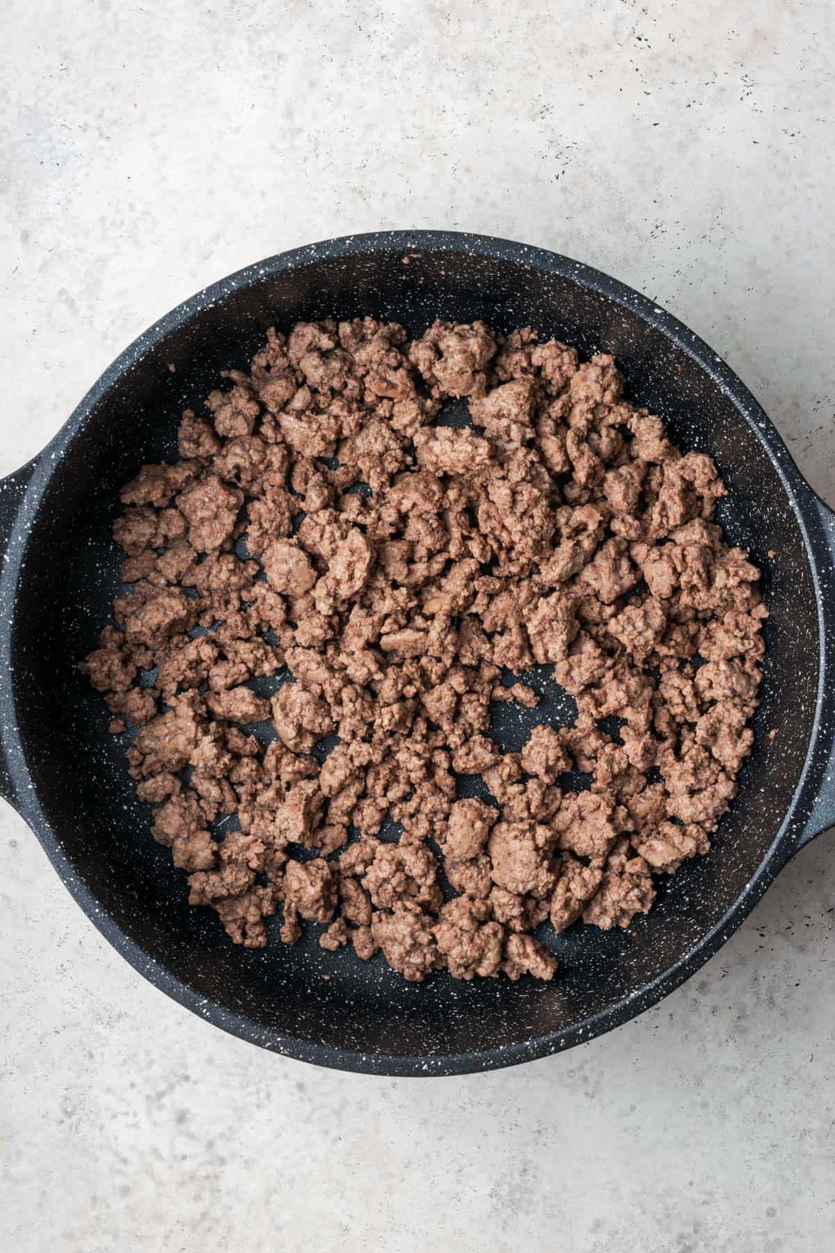 Browned ground beef in a large skillet.