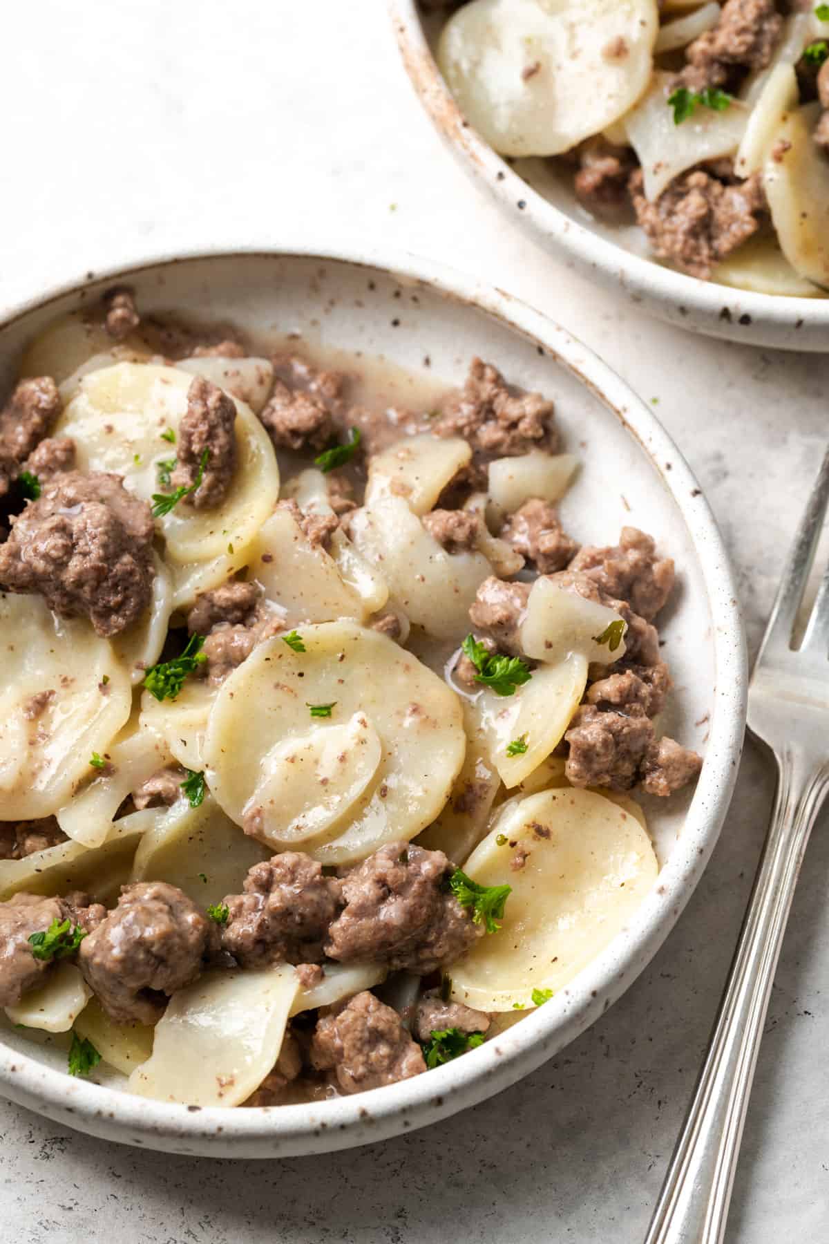 A white bowl filled with potato stroganoff homemade hamburger helper.