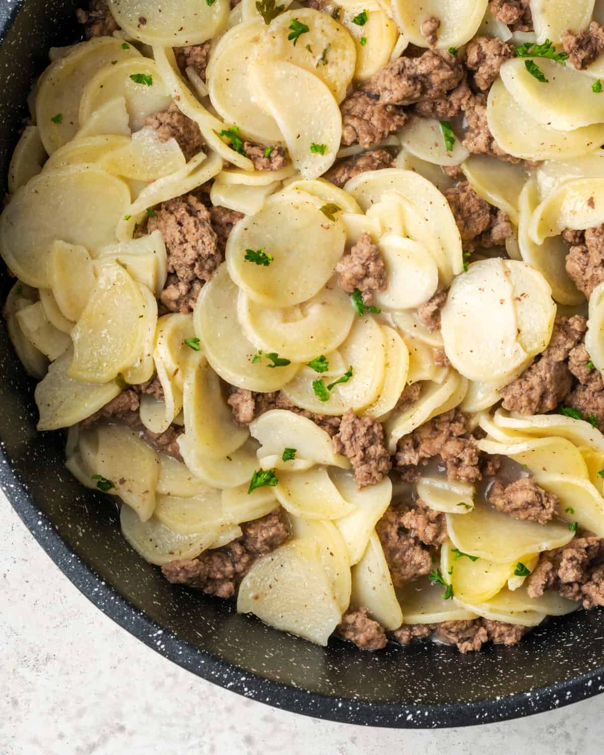 Cooked potatoes and ground beef in a flavorful sauce.