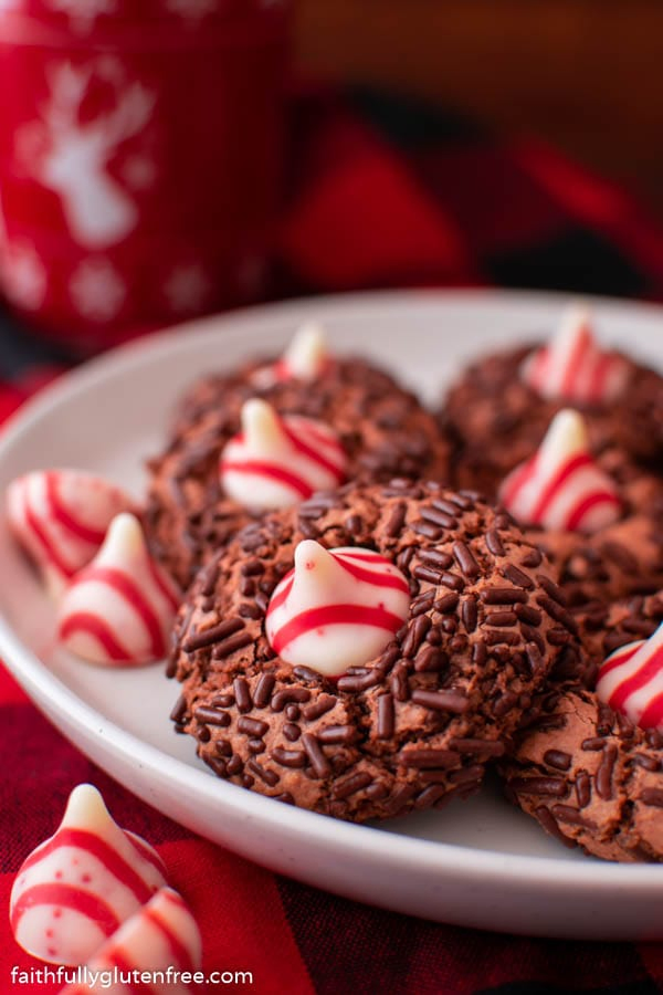 Chocolate candy cane kiss cookies on a white plate. 