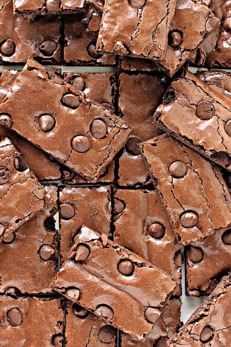 A pile of gluten free brownie brittle sprinkled with chocolate chips and cut into rectangles.