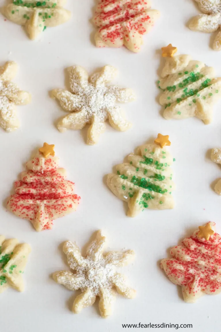 An assortment of gluten free spritz cookies on a white table.