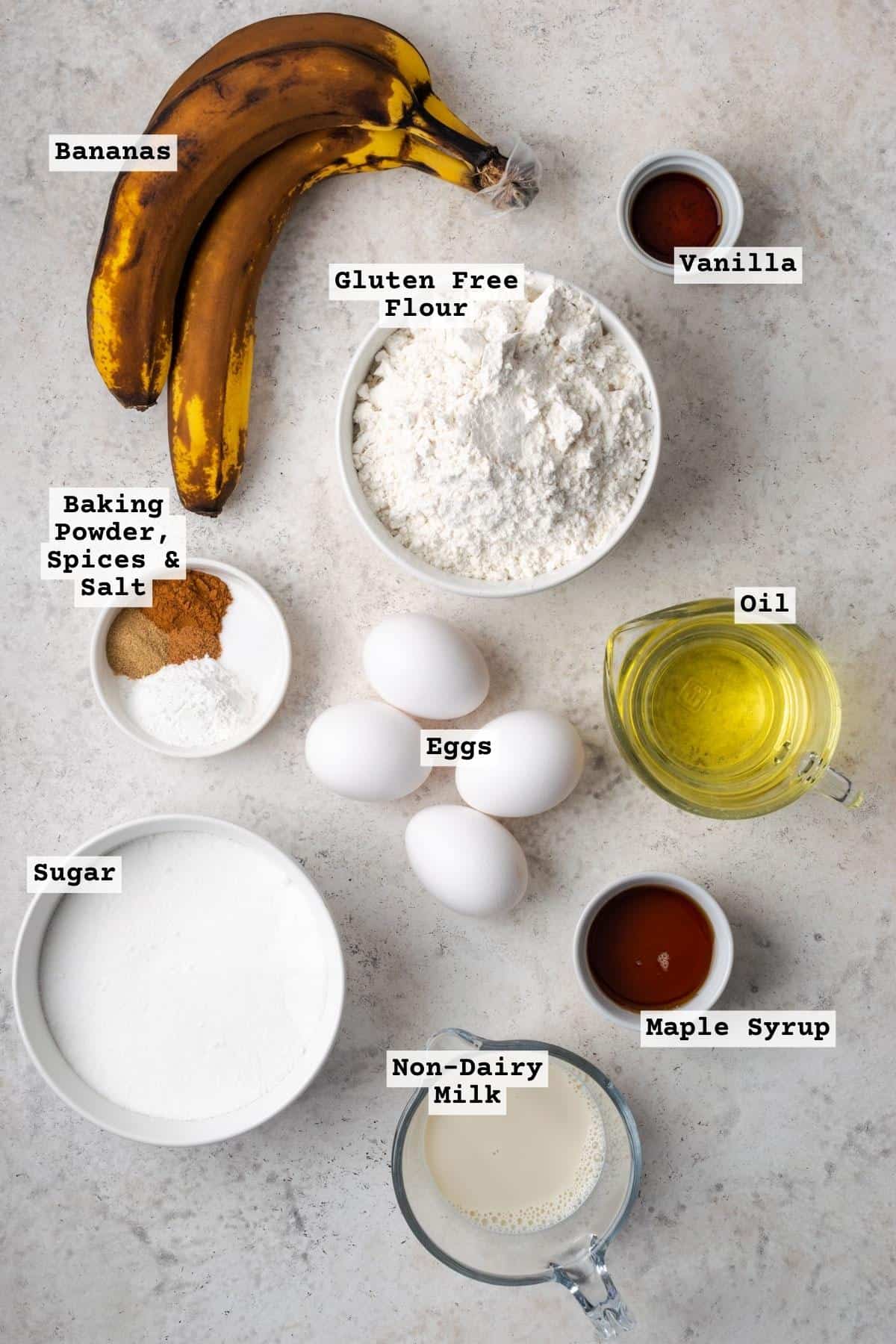 Ingredients for gluten free banana cake on a white table. 