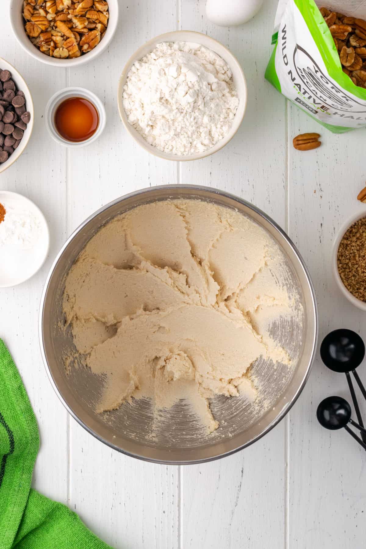 Butter and sugar creamed together in a large metal mixing bowl.