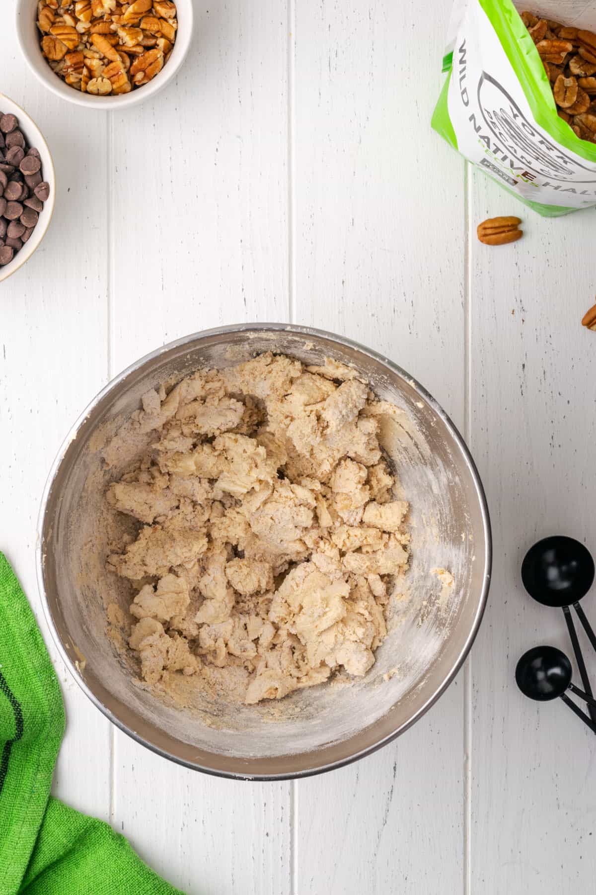 A partially mixed cookie dough with some streaks of flour still showing.