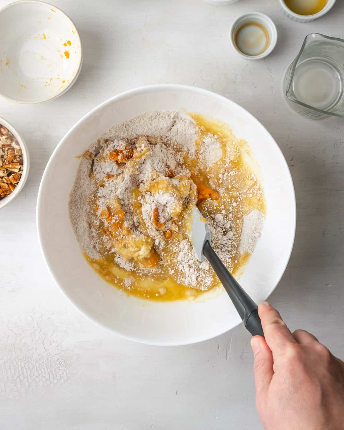 The wet ingredients being folded together with the dry ingredients.