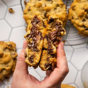 A Levain cookie cut in half revealing the gooey chocolate inside.