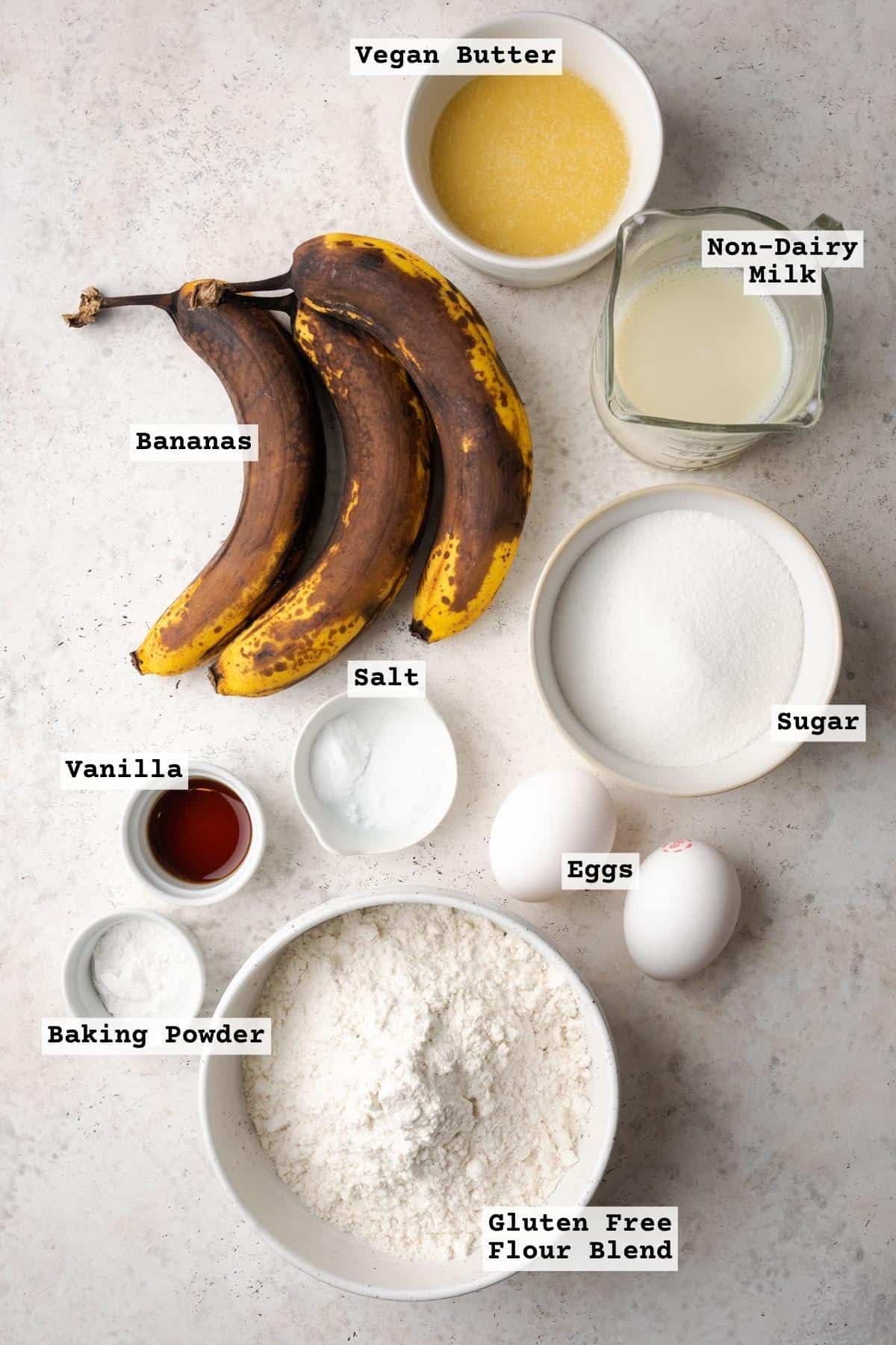 Ingredients for banana bread coffee cake on a white table.