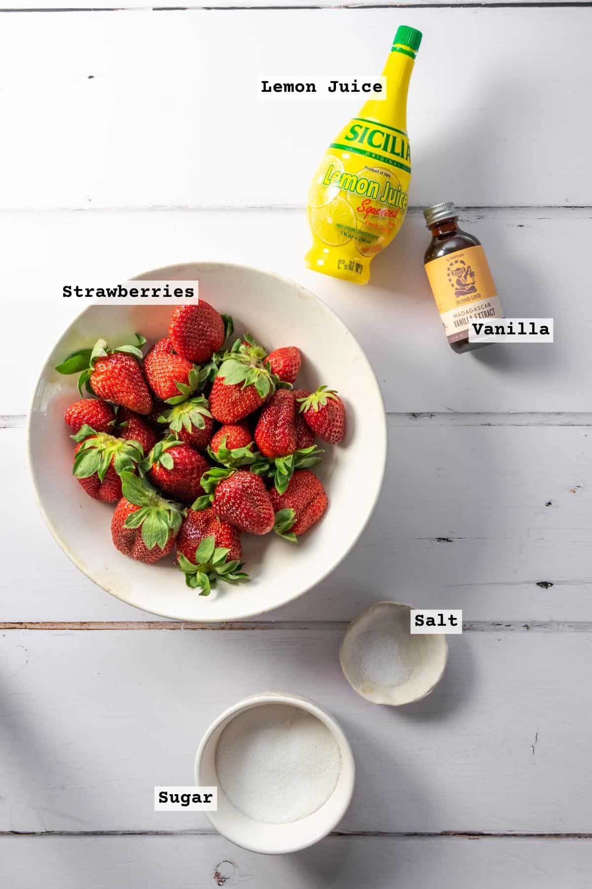 Ingredients for a strawberry galette on a white table.