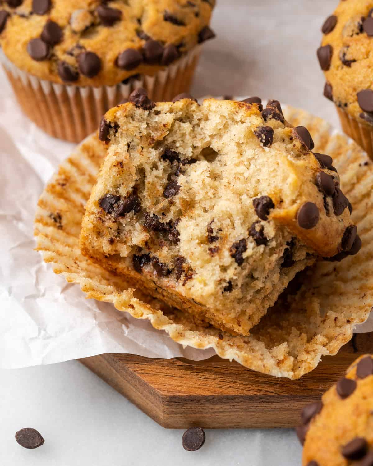 Closeup of a baked gluten free banana chocolate chip muffin with a bite taken out.