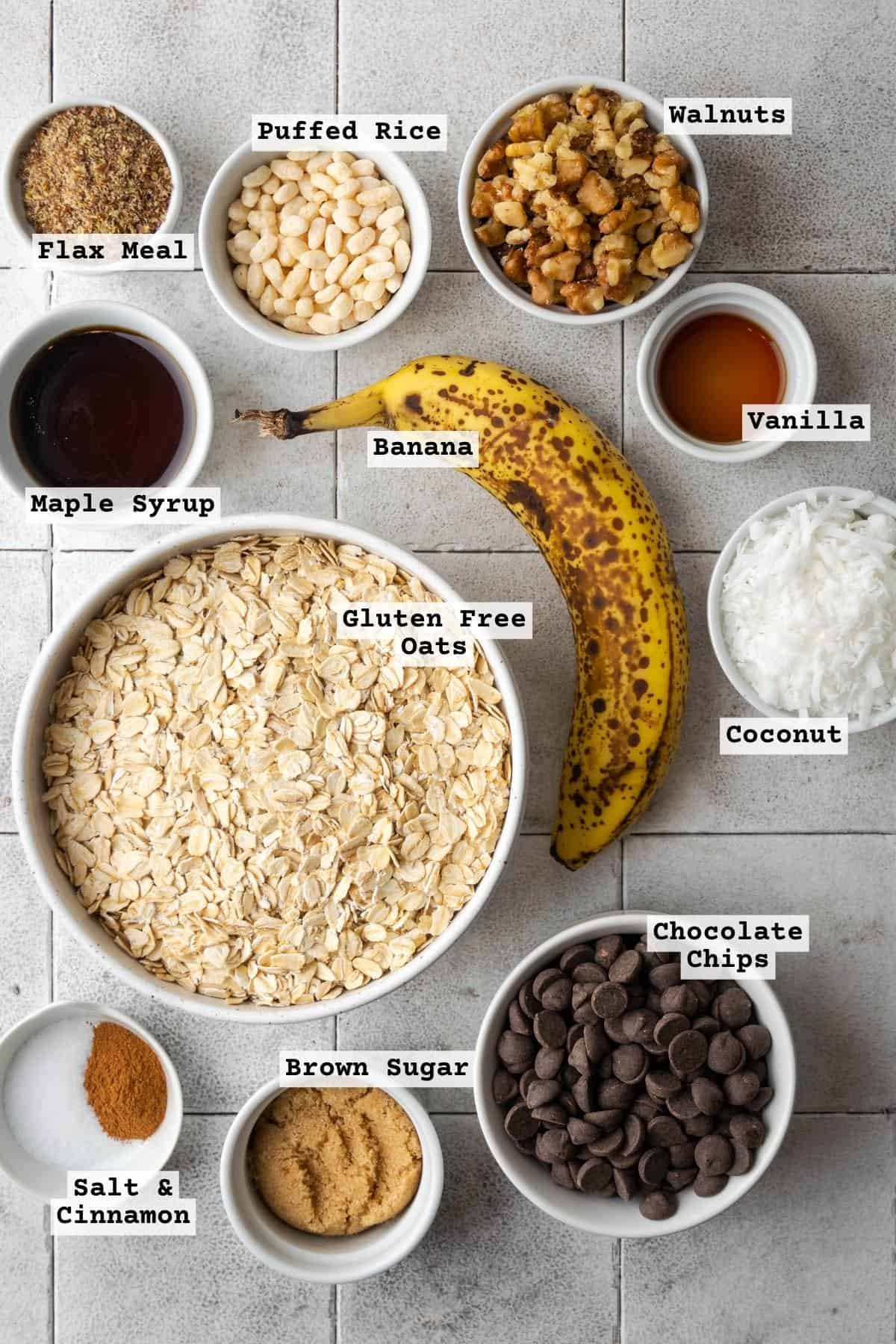 Ingredients for chocolate banana granola on a tile table.