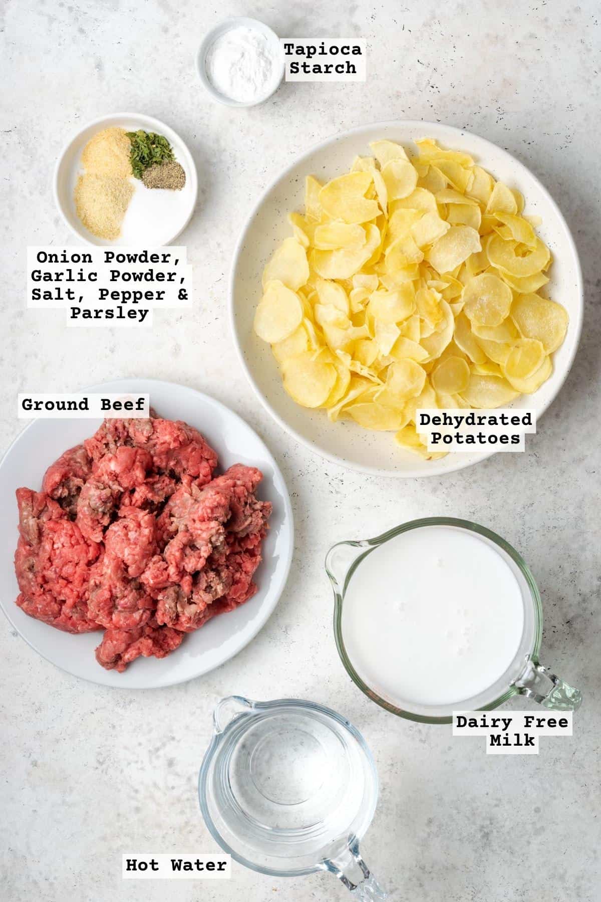 Ingredients for hamburger helper potato stroganoff on a white table.