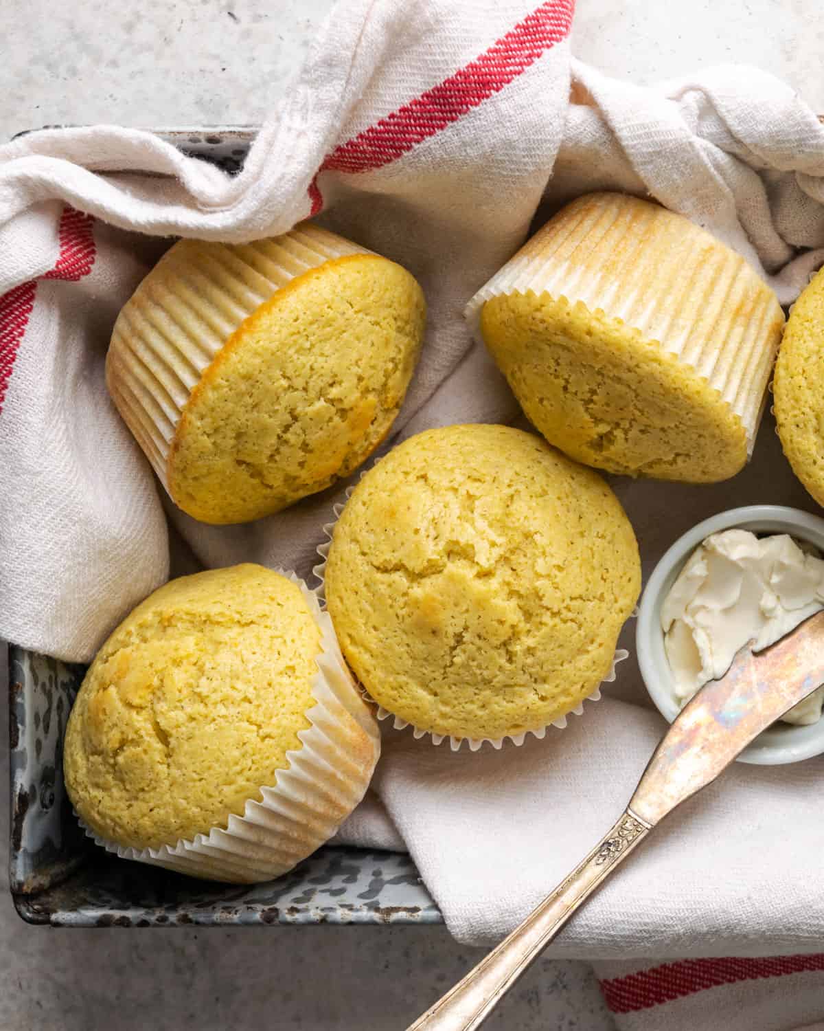 Gluten free corn muffins served in a metal tin.