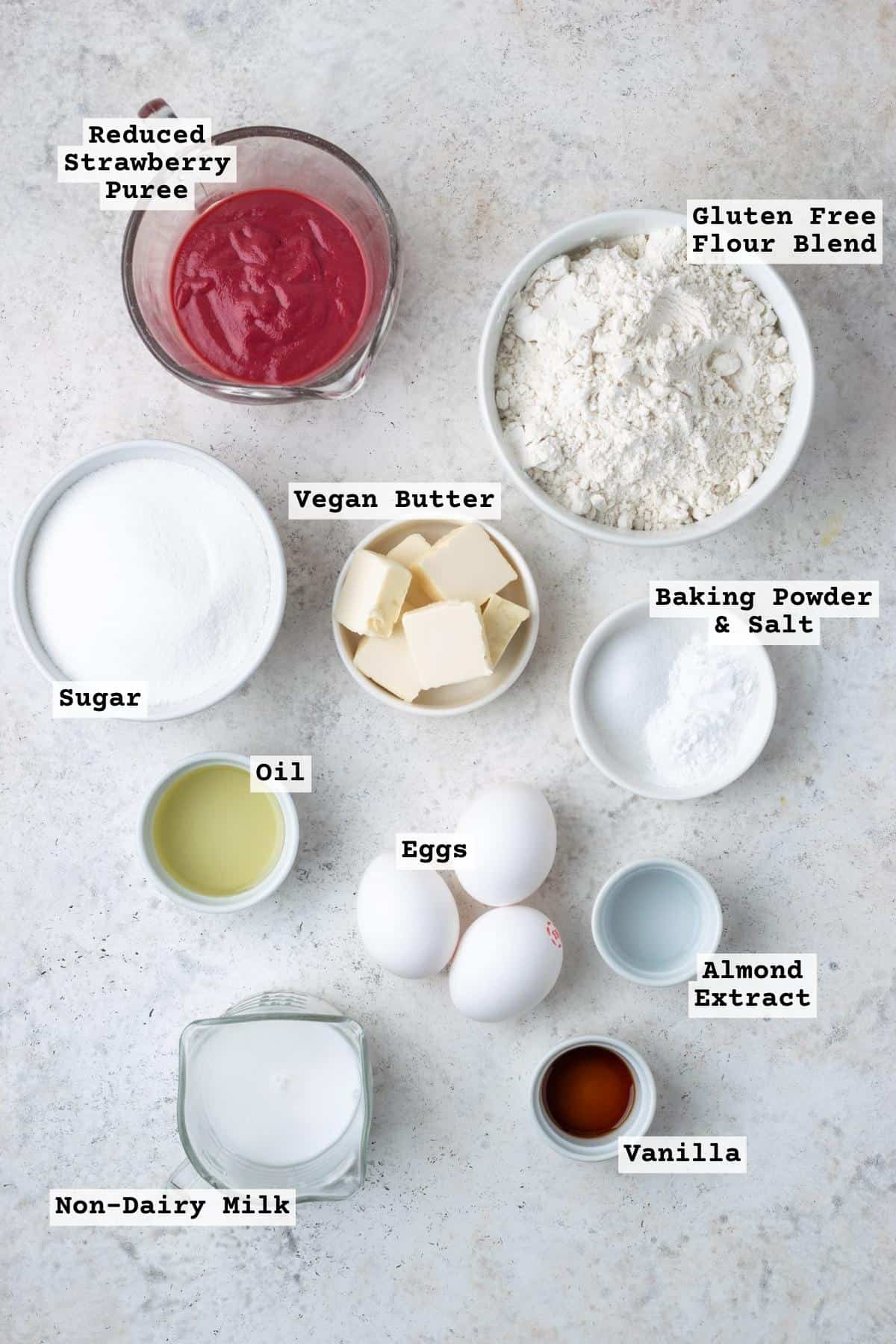 Ingredients for gluten free strawberry cake on a white table.