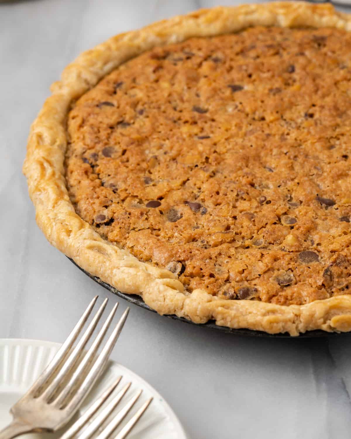 A freshly baked derby pie sitting on a white marble table.