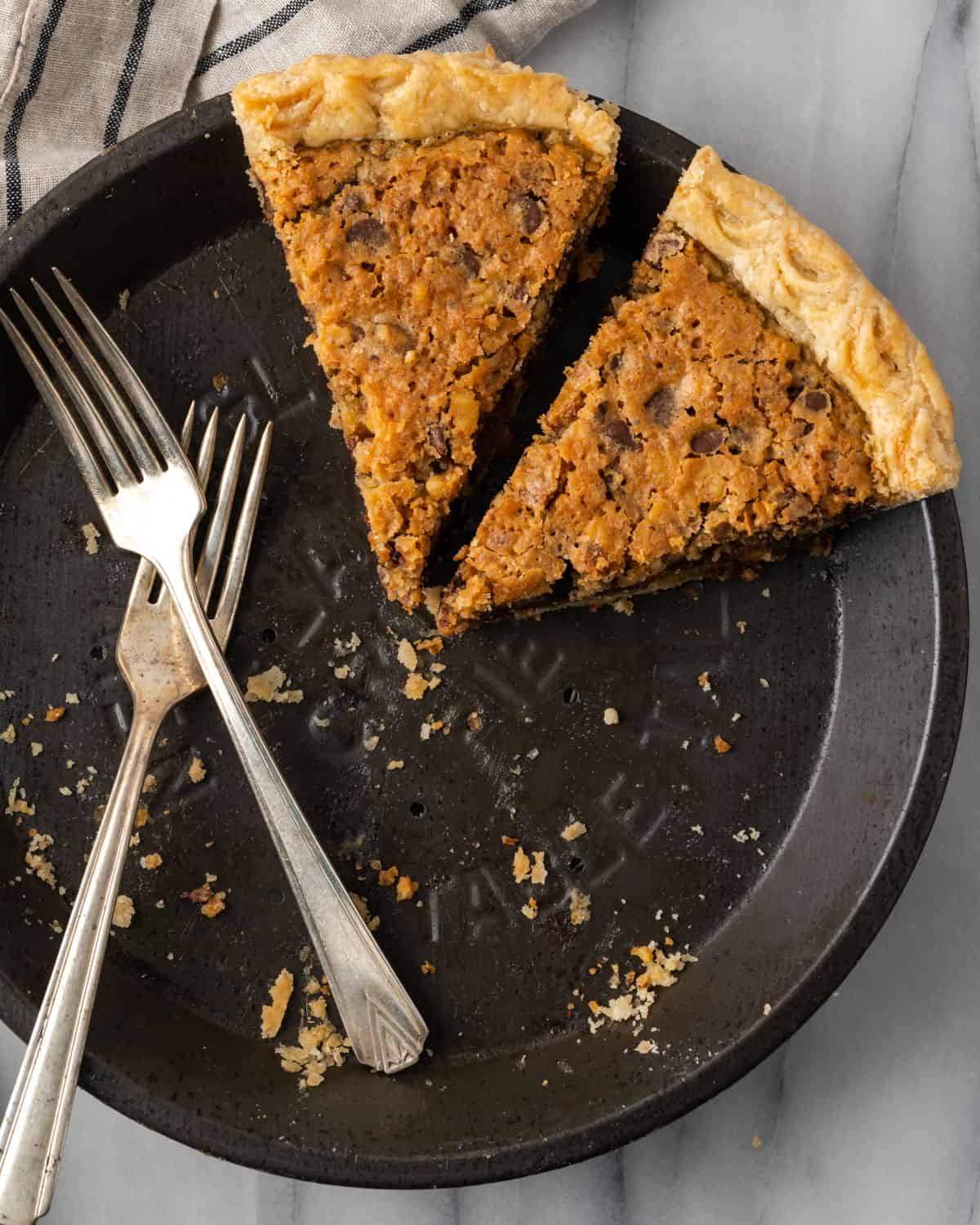 Two slices of pie left in a metal pie plate.