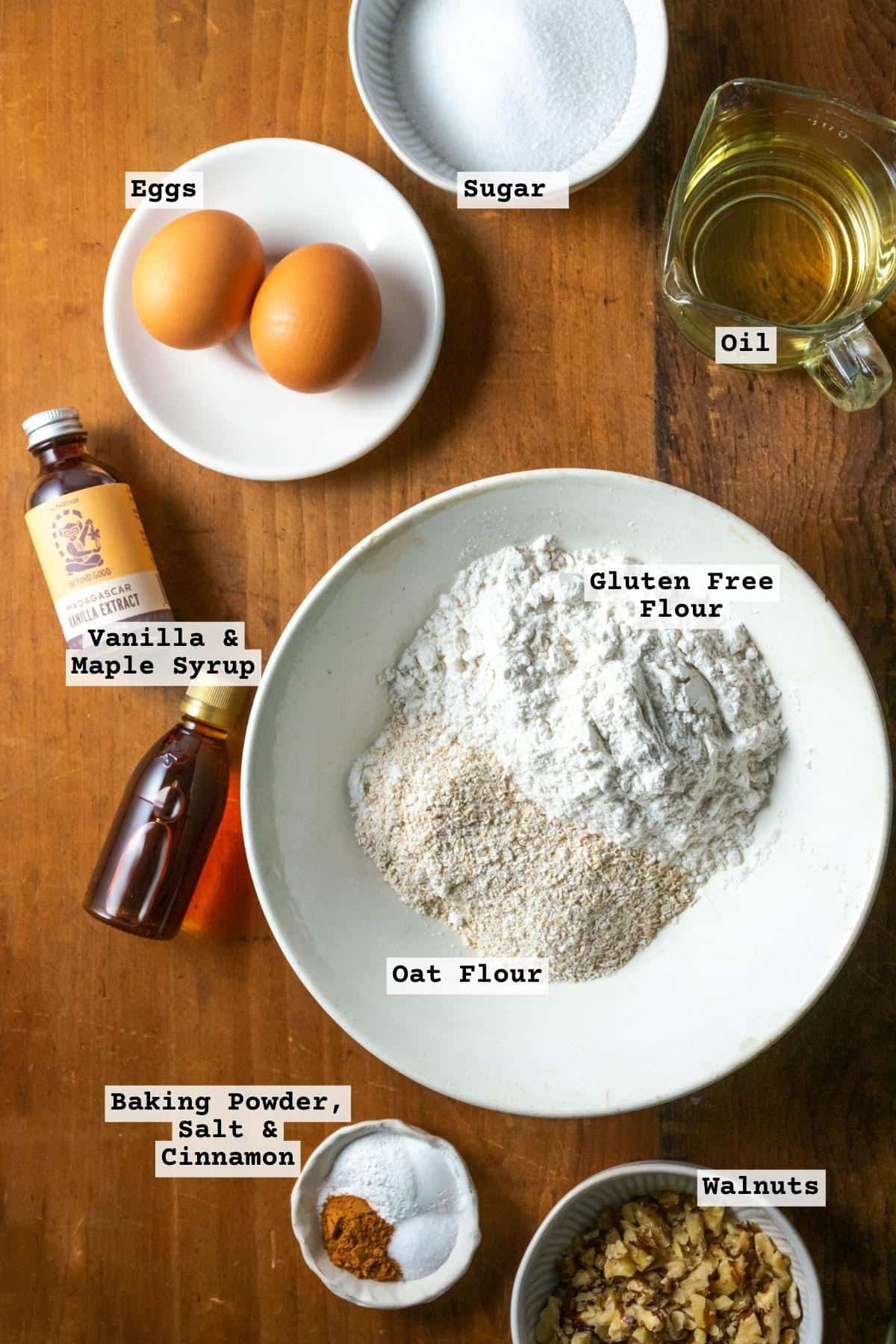 Ingredients for maple banana bread on a wood table.