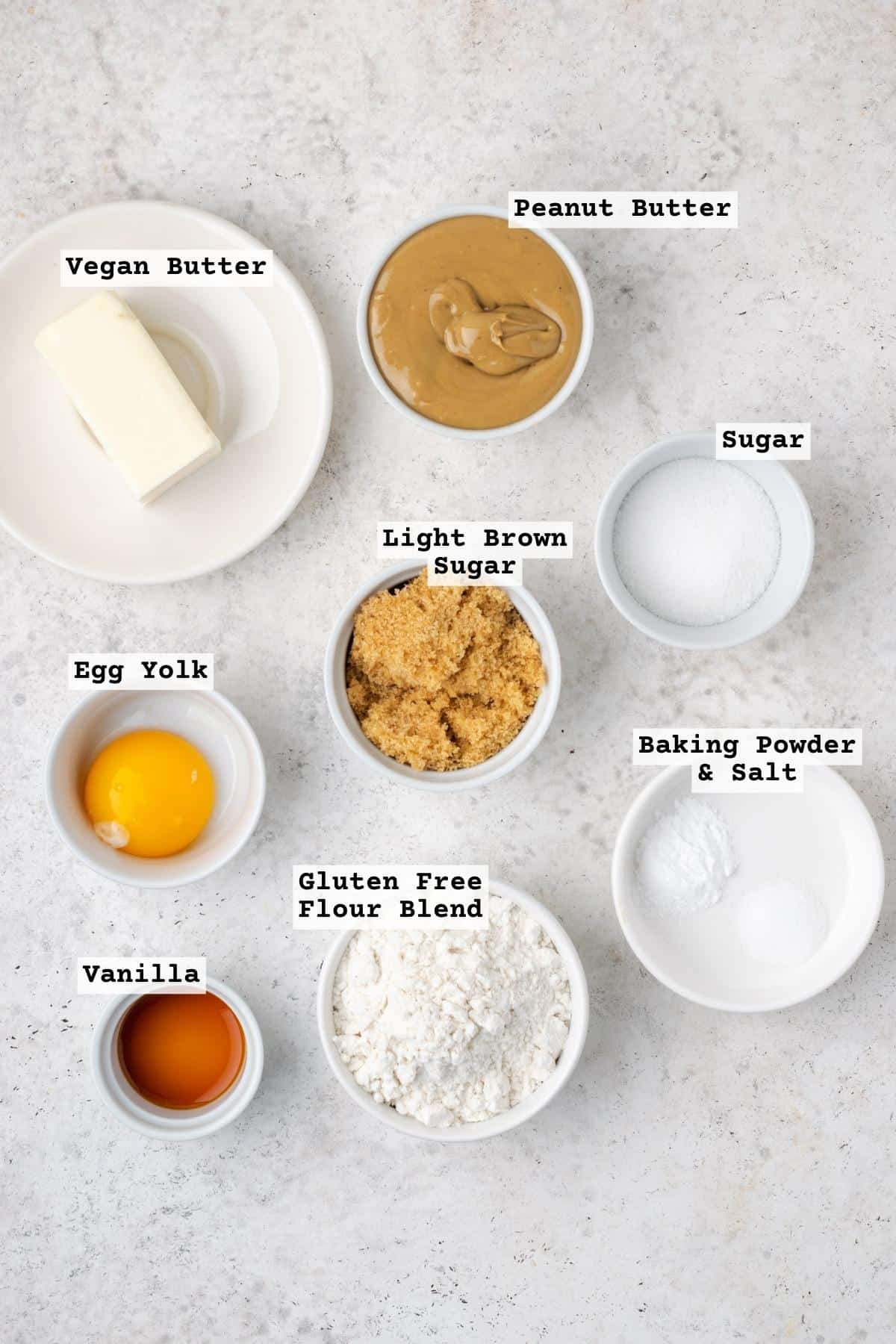 Ingredients for gluten free peanut butter cookies on a white table.