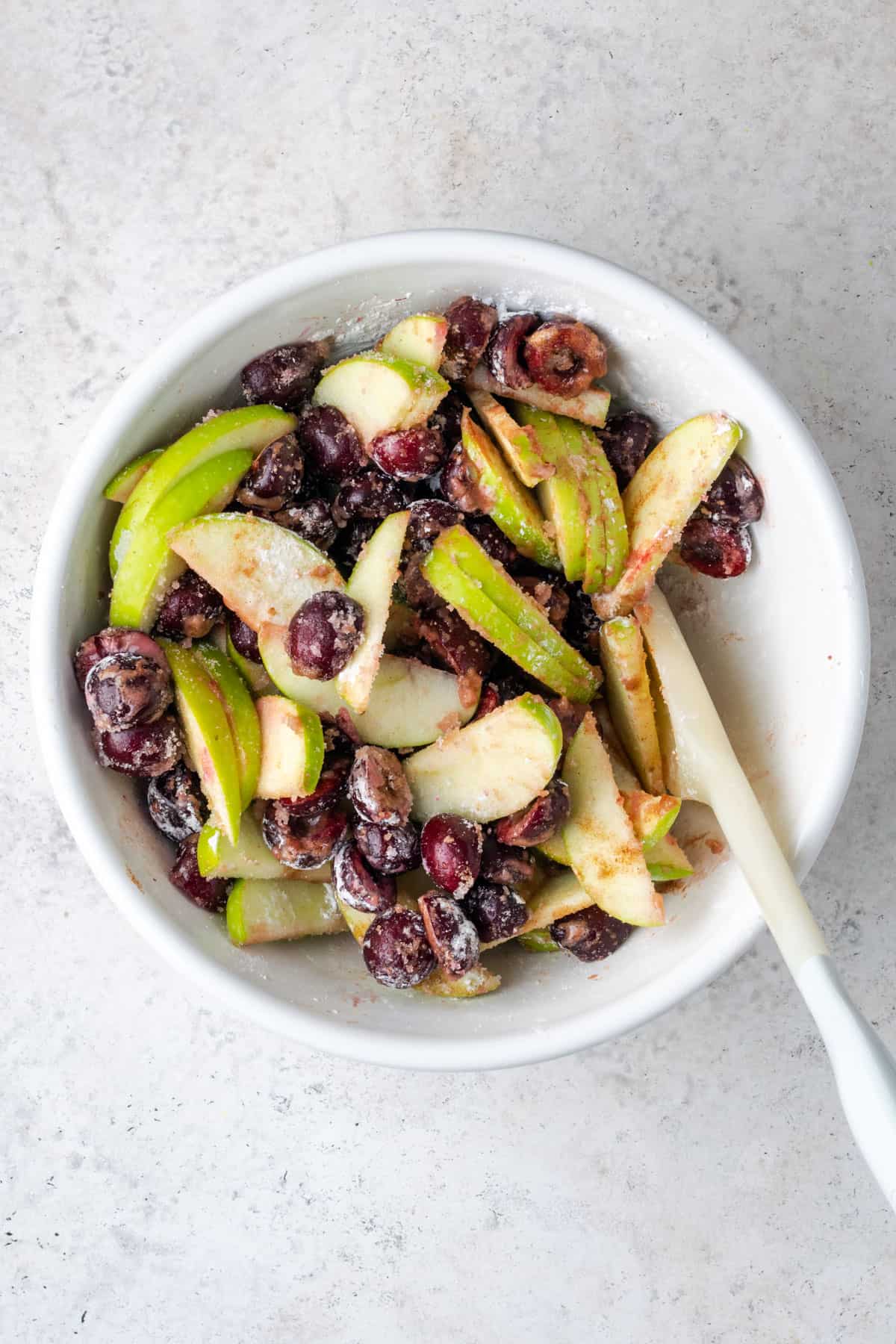 Pie filling ingredients all stirred together in a mixing bowl.