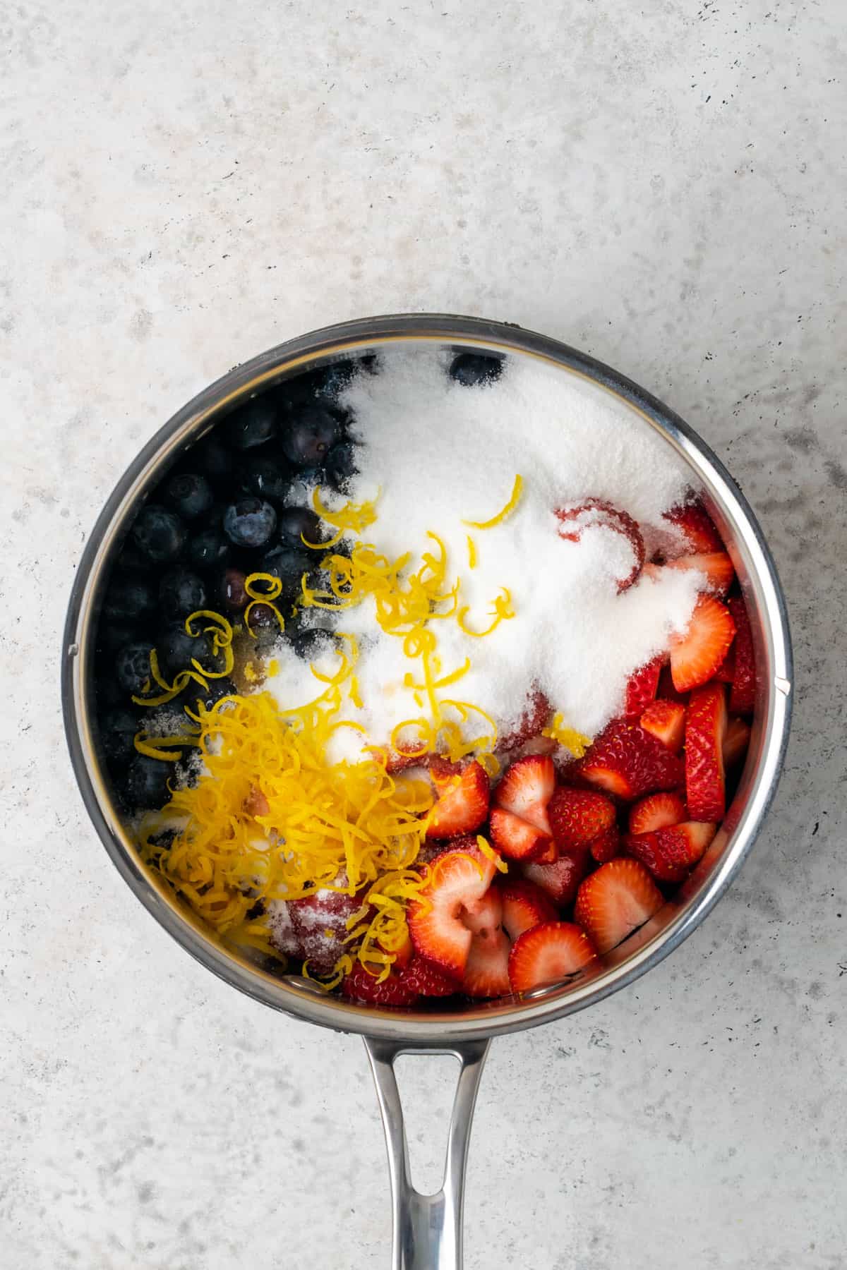 Strawberries, blueberries, lemon zest, sugar, vanilla and salt in a saucepan.