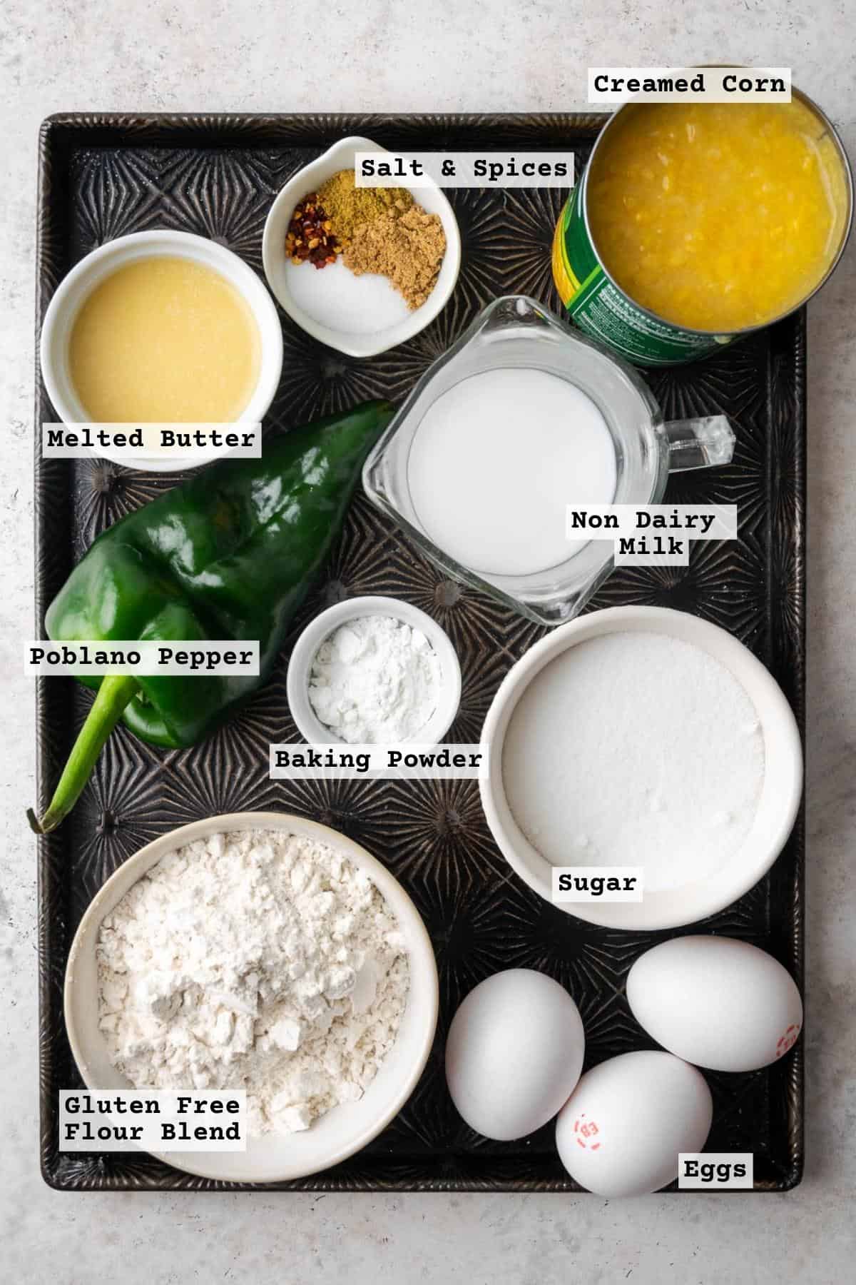 Ingredients for gluten free corn pudding on a metal baking sheet.