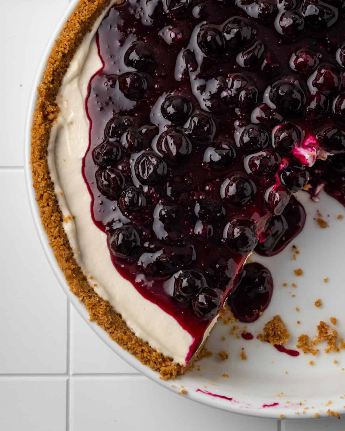 A gluten free no bake cheesecake topped with homemade blueberry sauce.