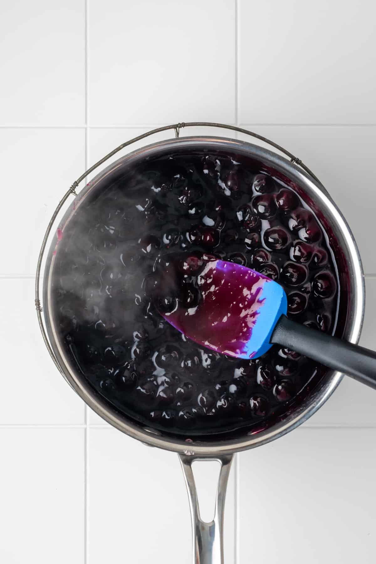 Thickened blueberry sauce shown coating a spatula.