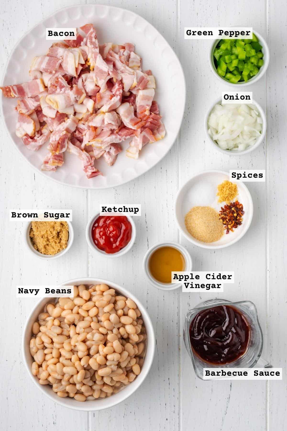 Ingredients for gluten free baked beans on a white wood table.