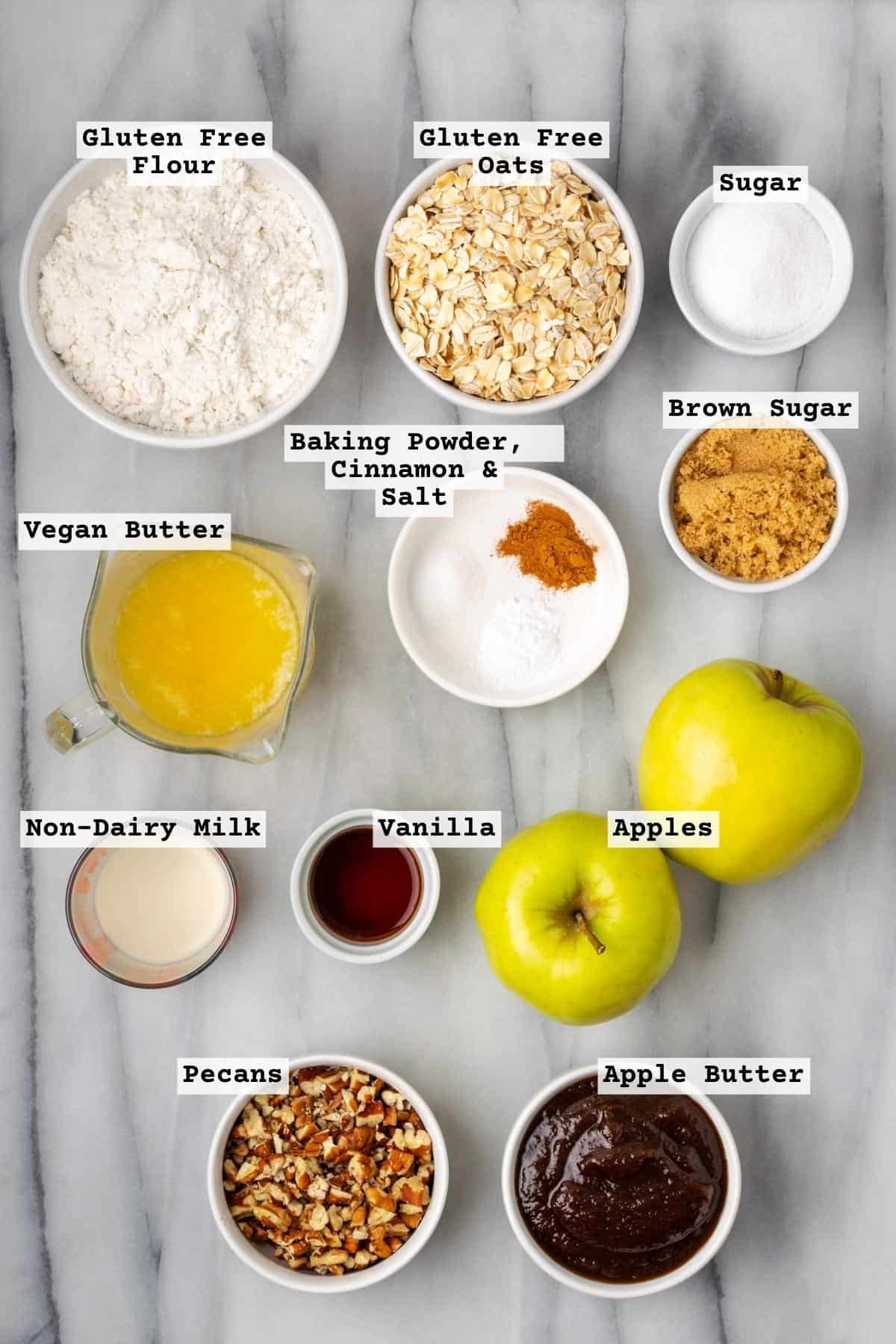 Ingredients for apple crumble bars on a white marble table. 