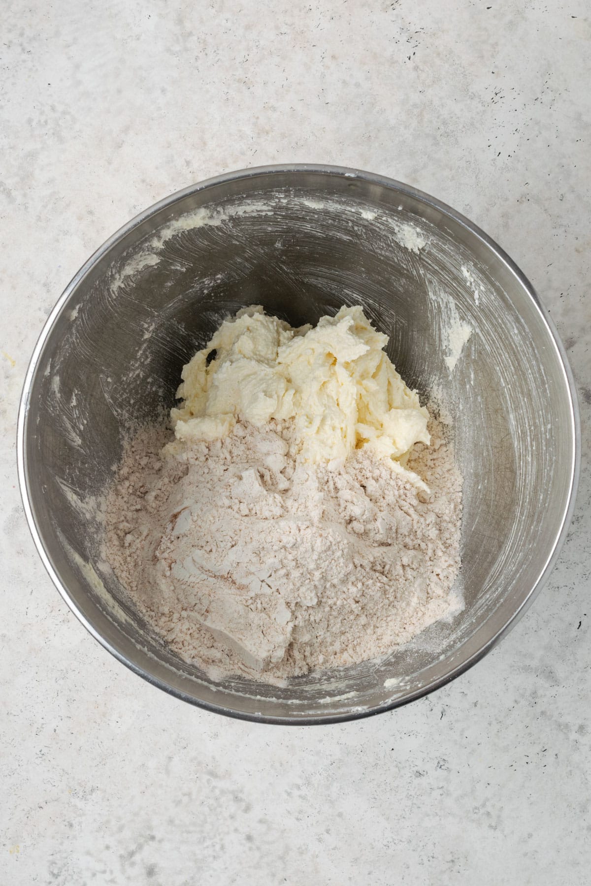 Dry ingredients added to the wet ingredients in a large mixing bowl.