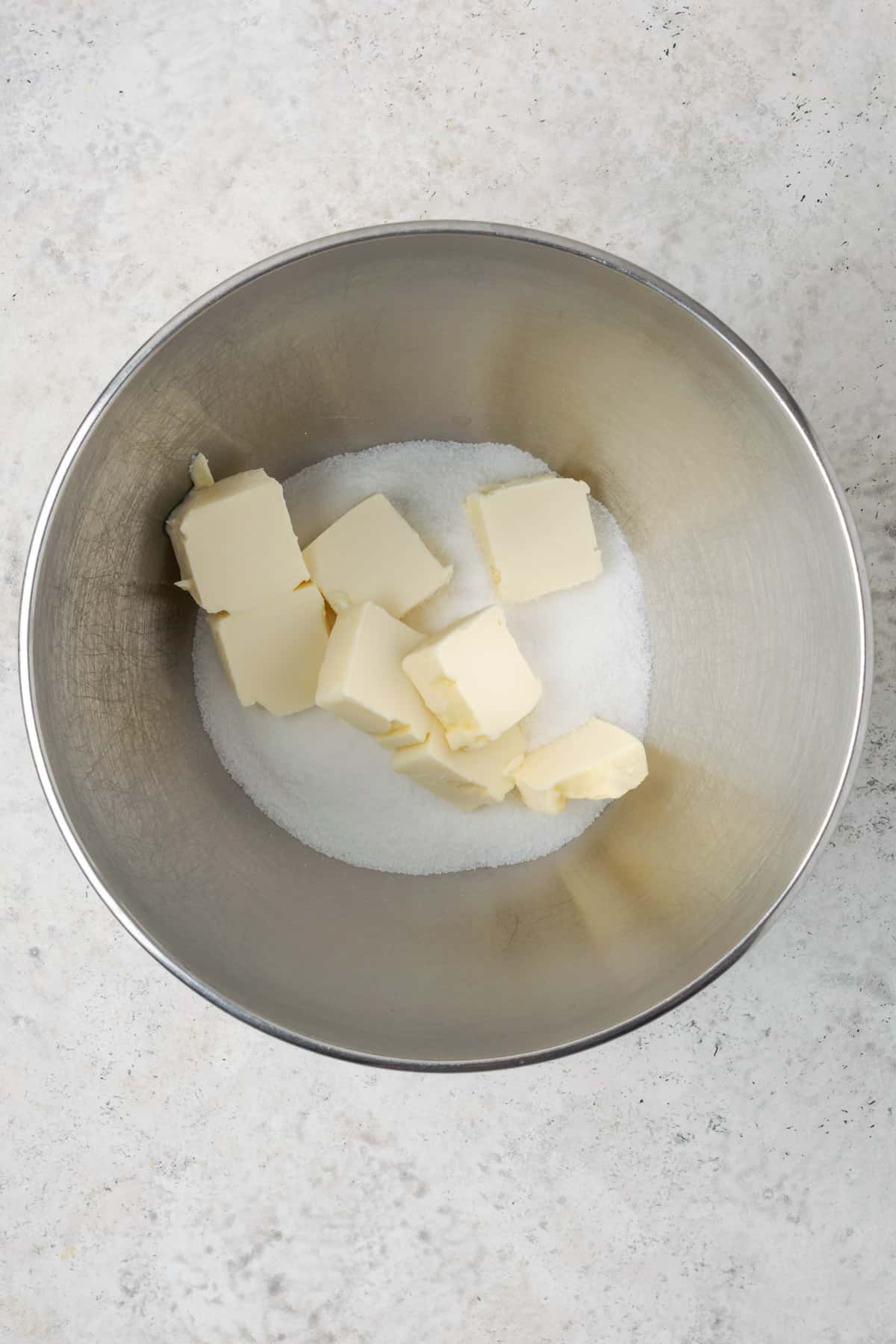 A large mixing bowl with butter and sugar. 