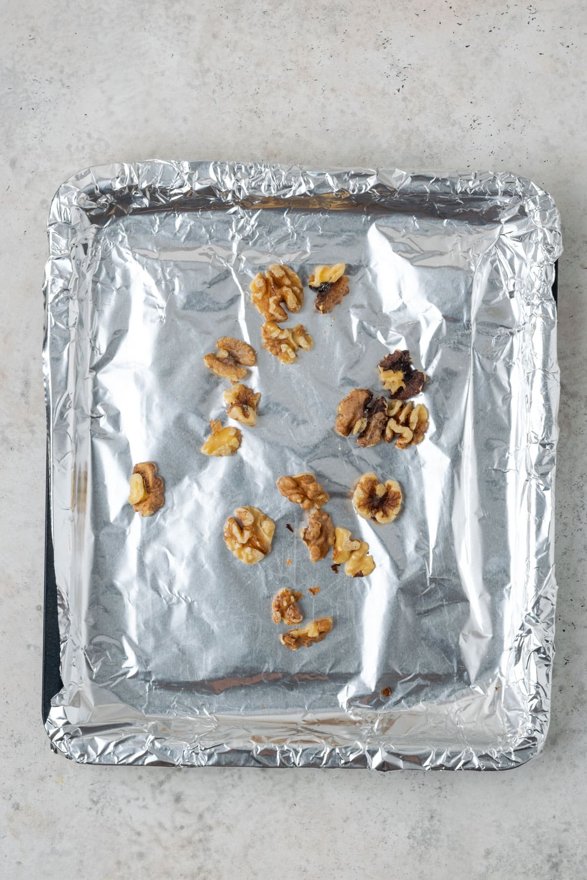 Walnuts on a foil line baking sheet.