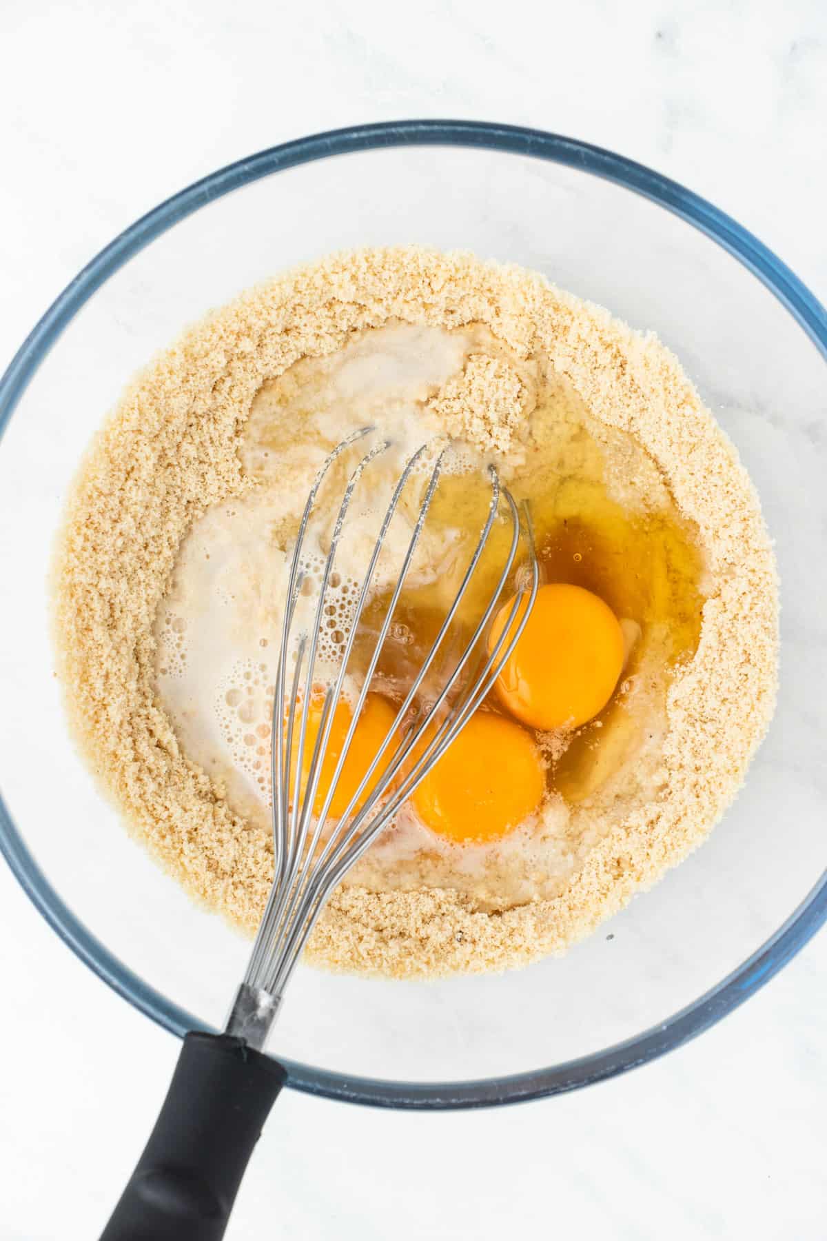 Milk, eggs and vanilla added to the dry ingredients in a large mixing bowl.