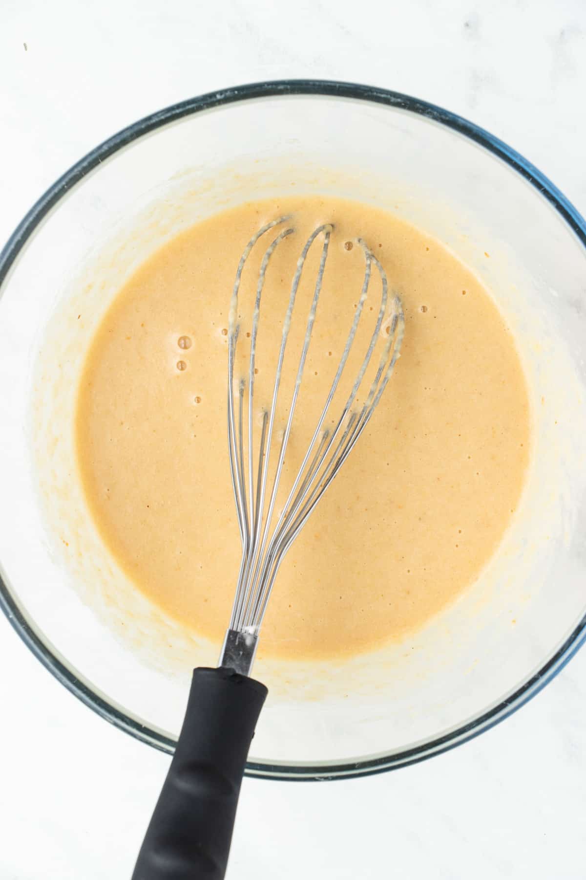 Almond flour pancake batter resting in a large mixing bowl. 