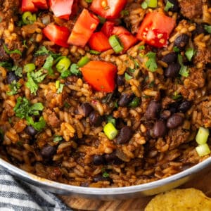 Mexican beef and rice skillet topped with diced tomatoes, green onions and cilantro.