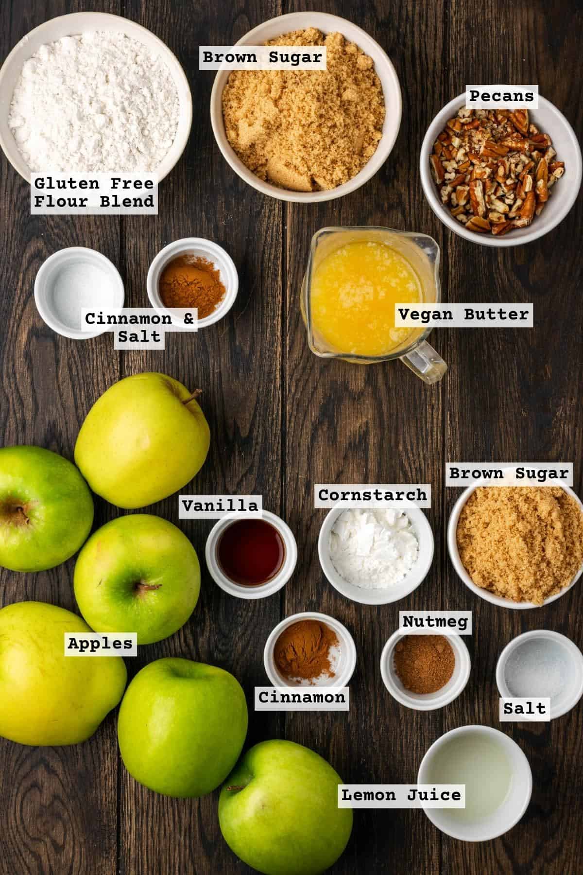 Ingredients for a gluten free apple crumble laying on a wood table.